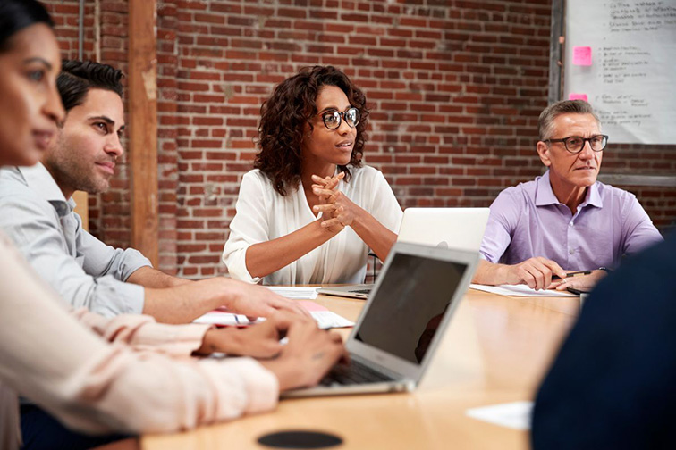 Business people meeting around a table.